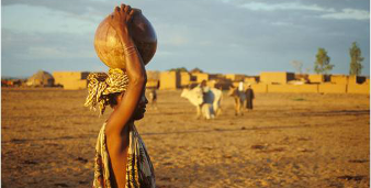 person with a calabash on her head